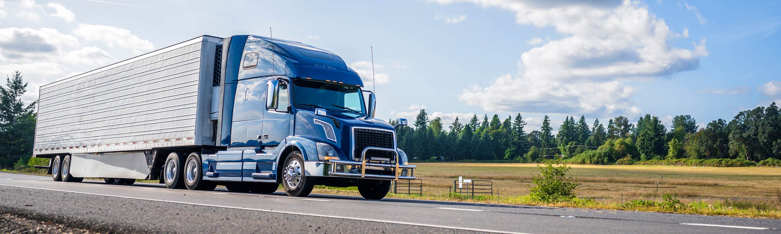 Supply chain recruiters, image of blue semi rig on highway